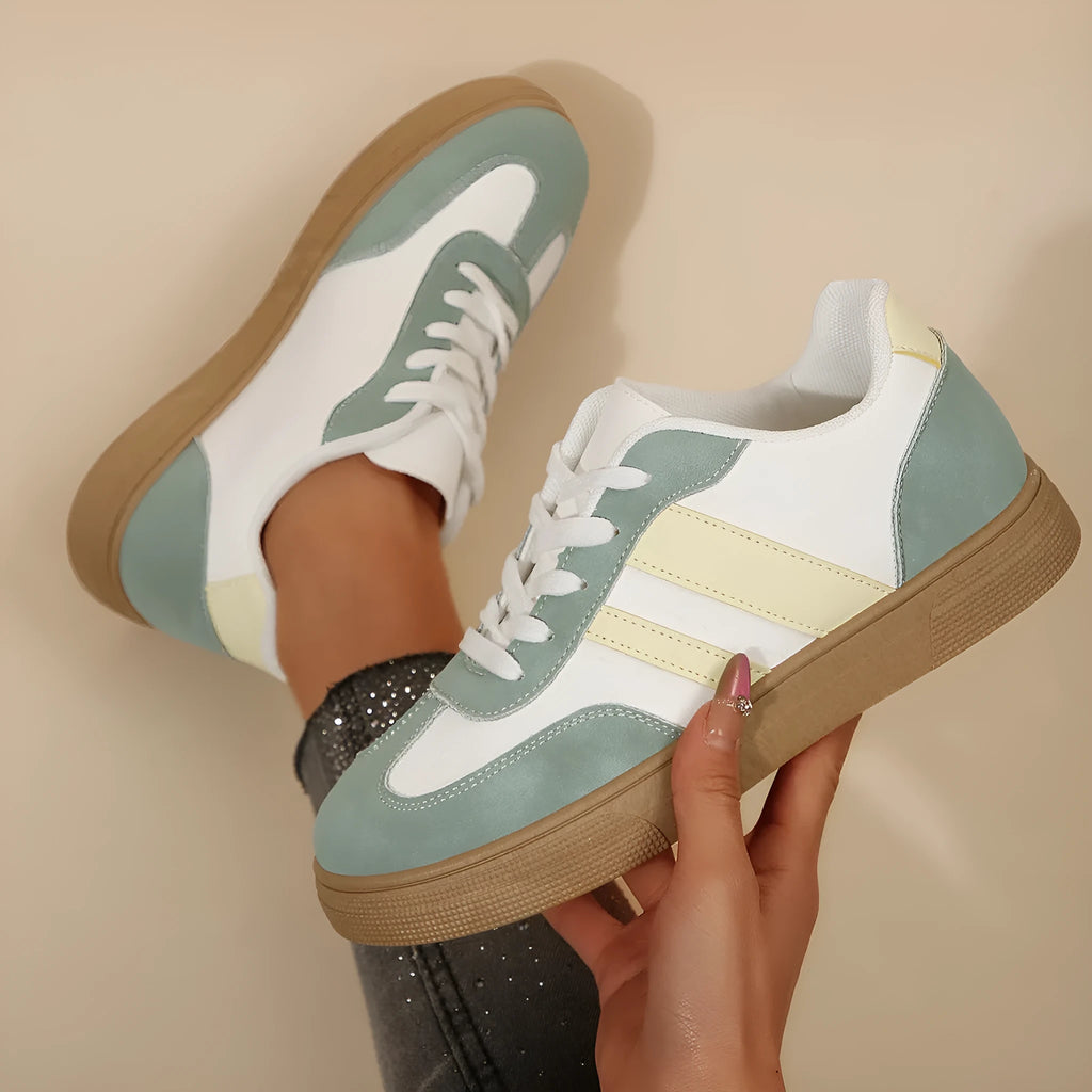 Green retro women's low-top pumps with cross straps, round toe, and flat rubber sole on a white background.