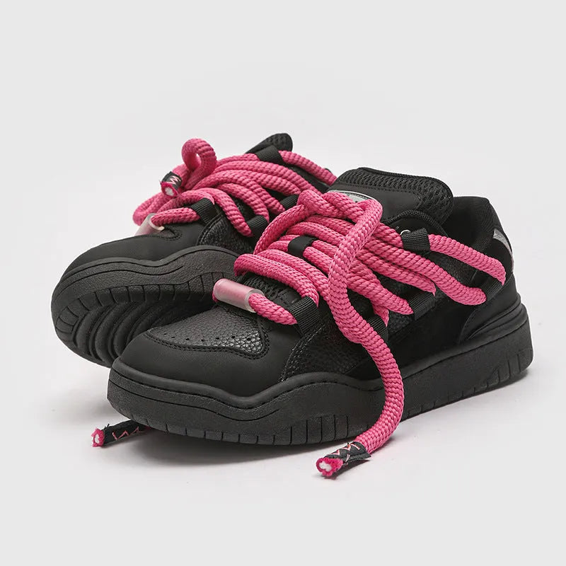 A pair of low-top casual sneakers with a thick rubber sole and front lace-up closure, shown in a choice of four colours.