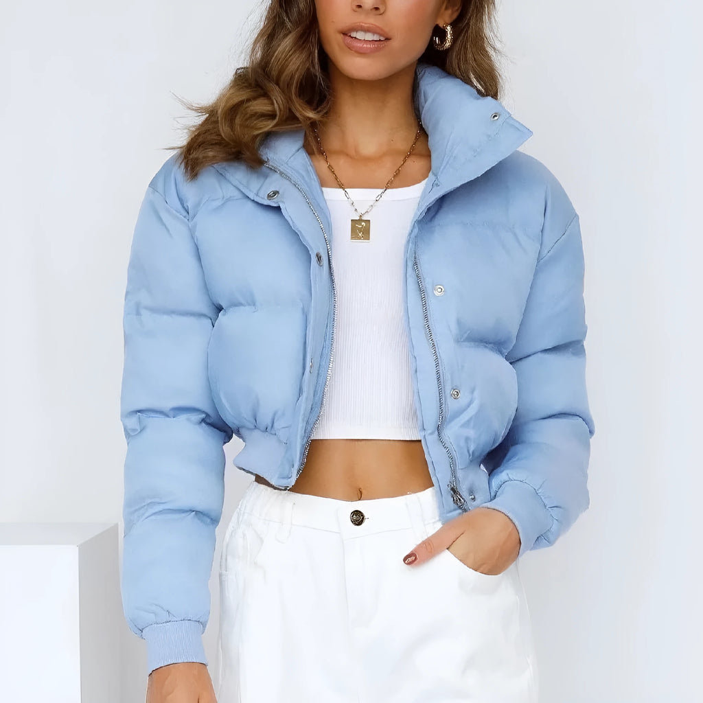 Women's loose-fit blue polyester jacket with long sleeves on a hanger.