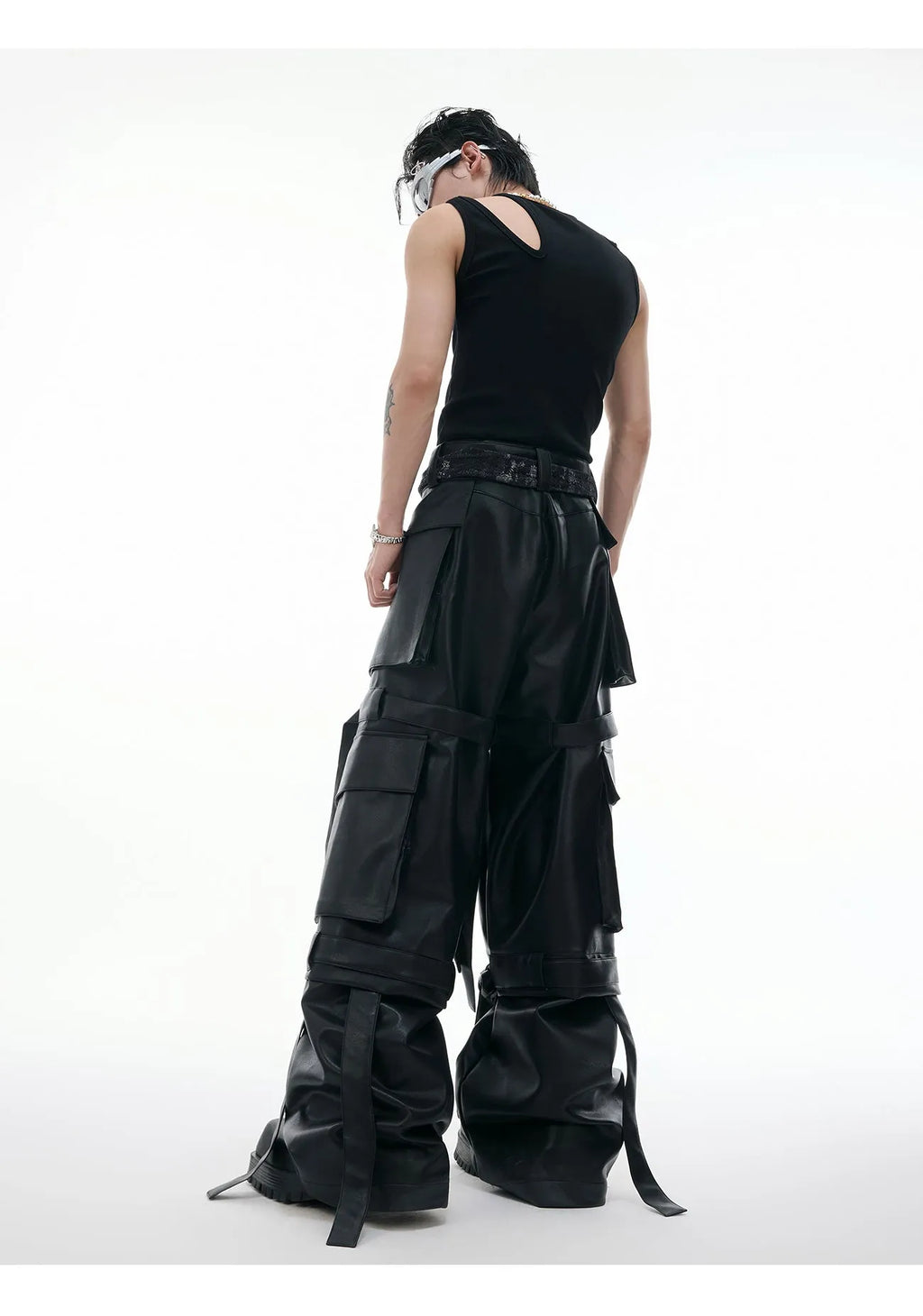 Men's black loose fit leather trousers with quilted detailing and multiple pockets