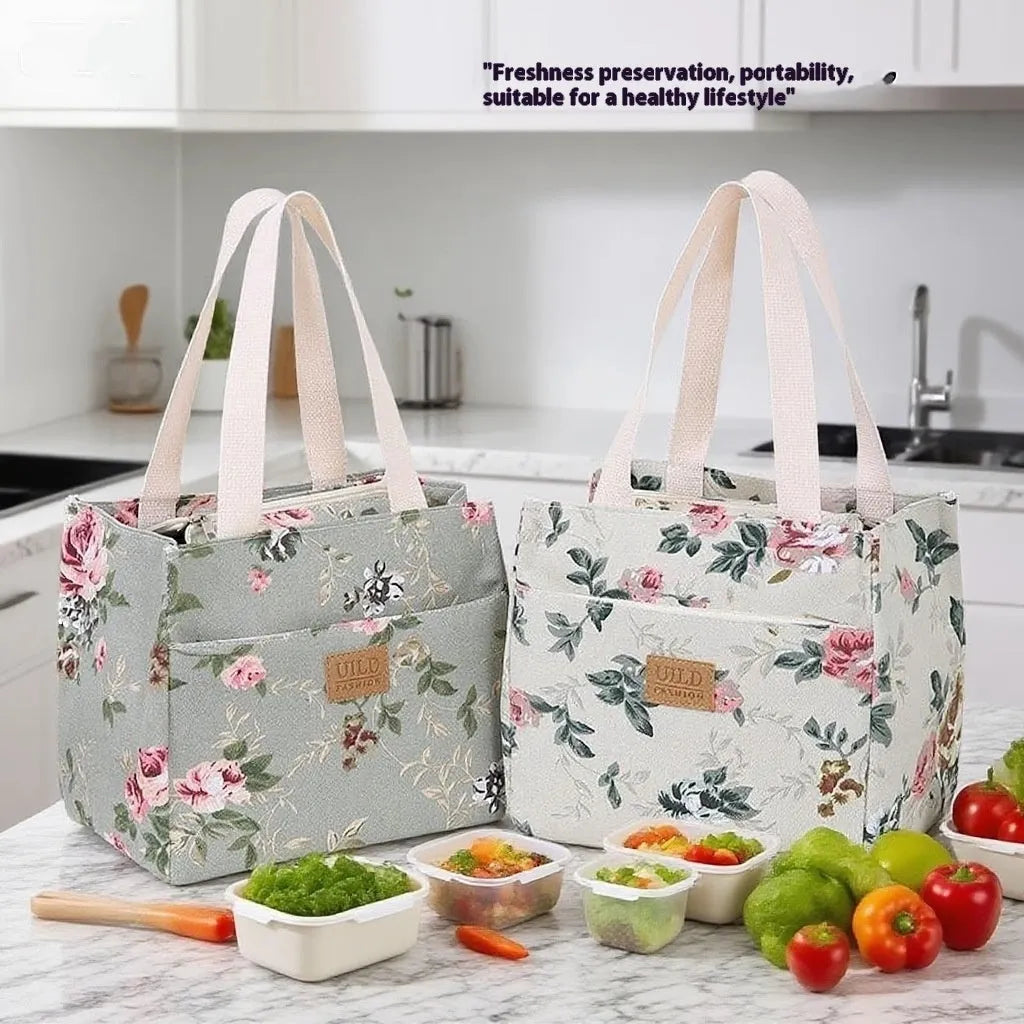 Women's printed canvas handbag showing floral or cat design on black, blue or pink background