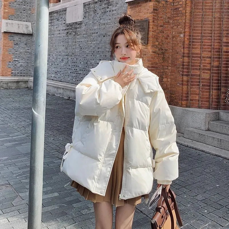 Women's milky white sleeveless insulated jacket with princess sleeves on a hanger