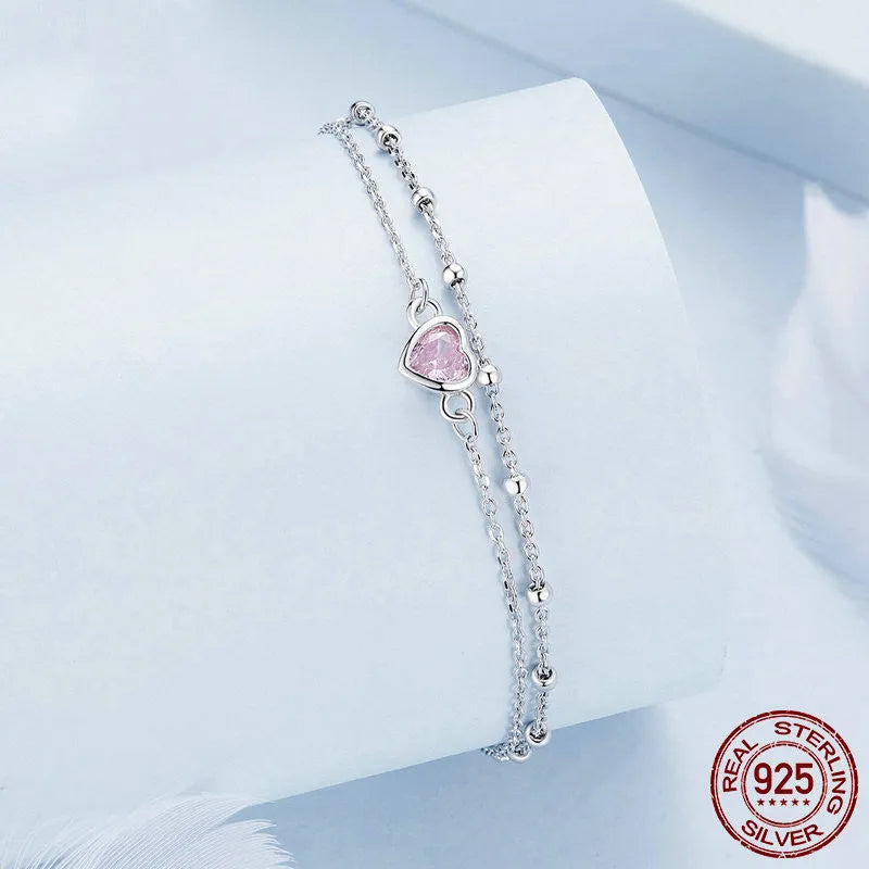 Women's 925 sterling silver bracelet with a small heart-shaped pendant on an adjustable chain.