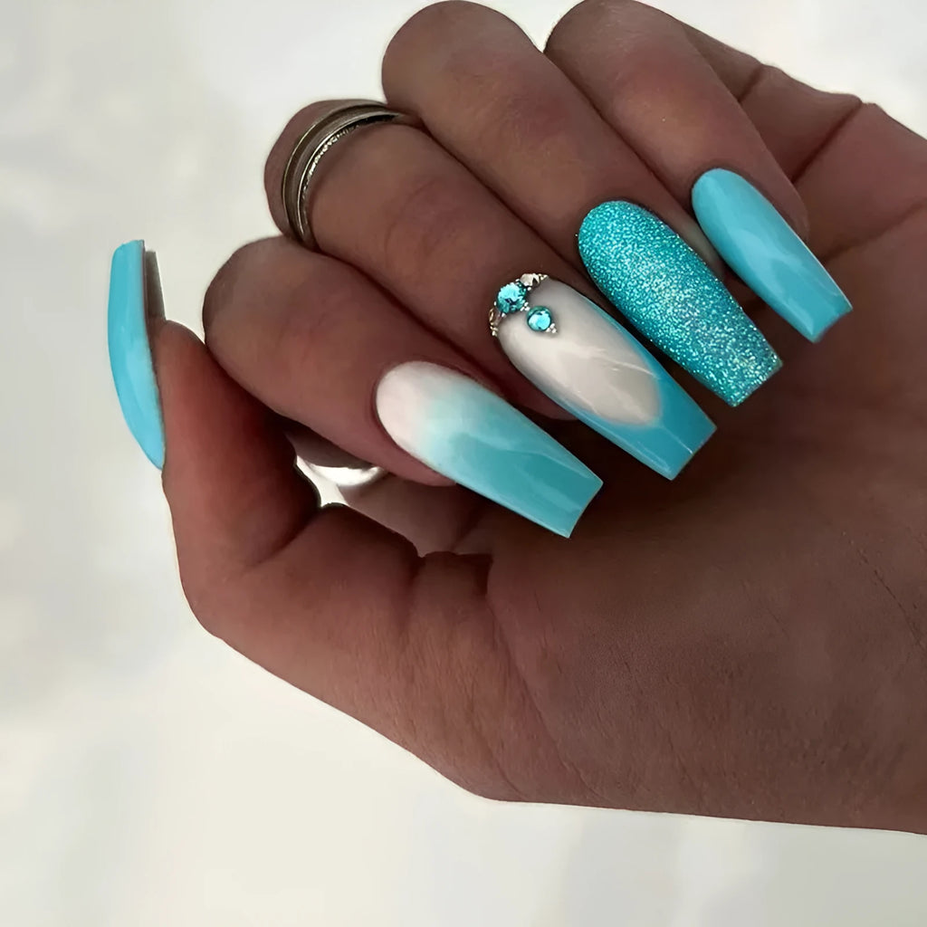 Long oval ballet false nail art patches with a solid smart blue diamond design and glue bottle.