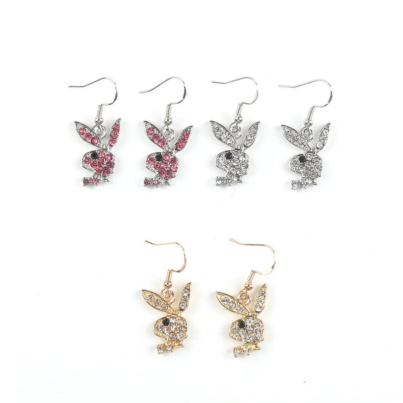 A pair of cartoon rabbit stud earrings with a full diamond design, shown in gold, pink, and silver colour options.