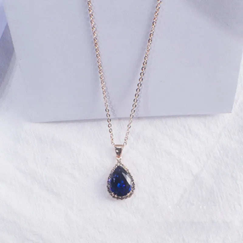 Drop-shaped pendant necklace with rhinestone and gemstone inlay in pink colour option
