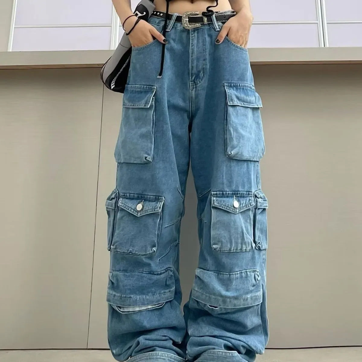 Women's blue tie-dyed wide-leg high-waist jeans with multiple pockets on a mannequin.