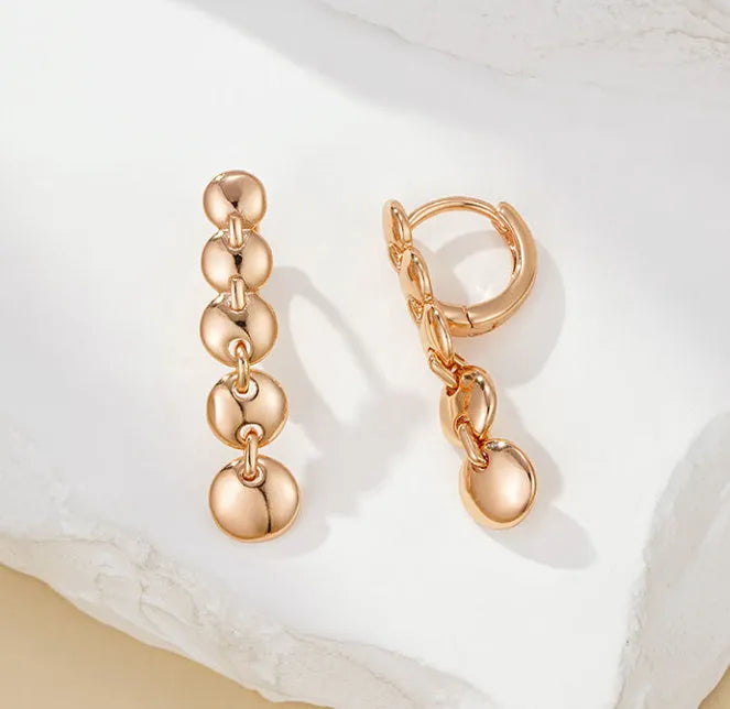A pair of gold-coloured retro long round circle earrings with a woven texture, made from copper.