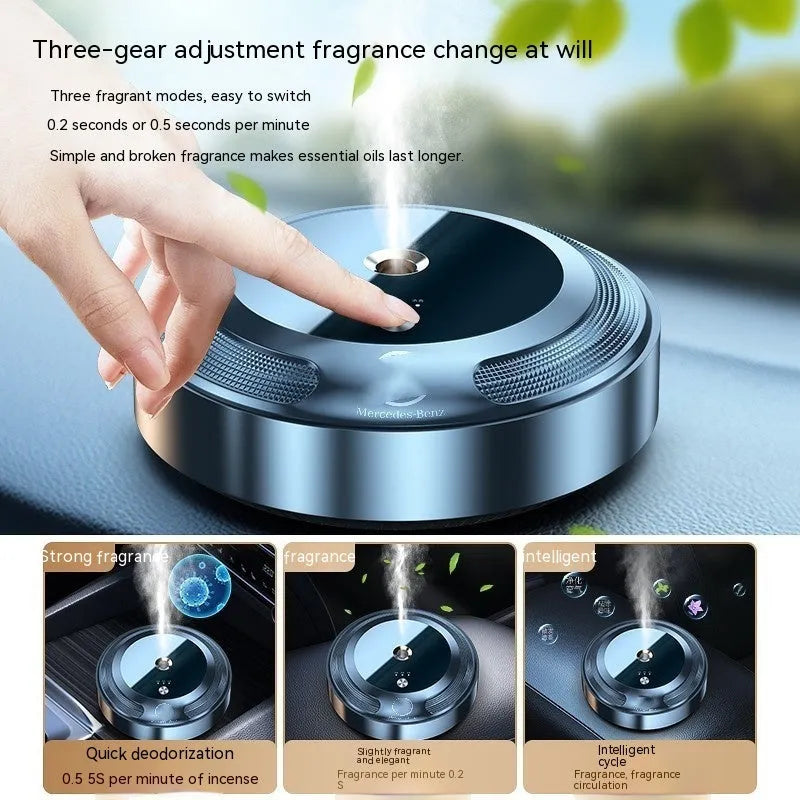 Silver automatic car air freshener diffuser with zinc alloy metal shell on anti-slip pad.