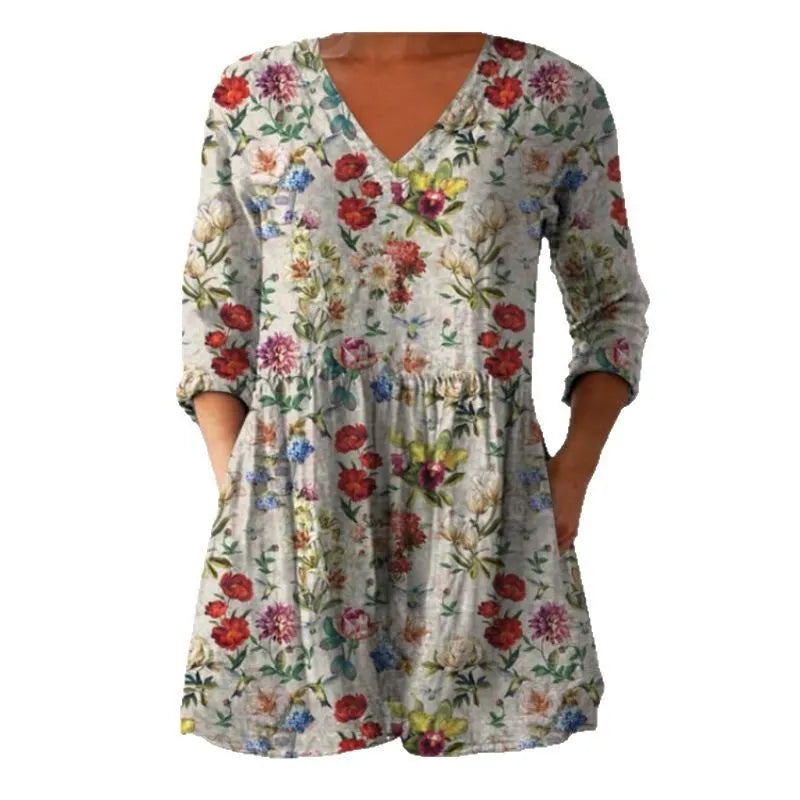 Women's printed loose-fitting dress with wide waist and three-quarter length sleeves.