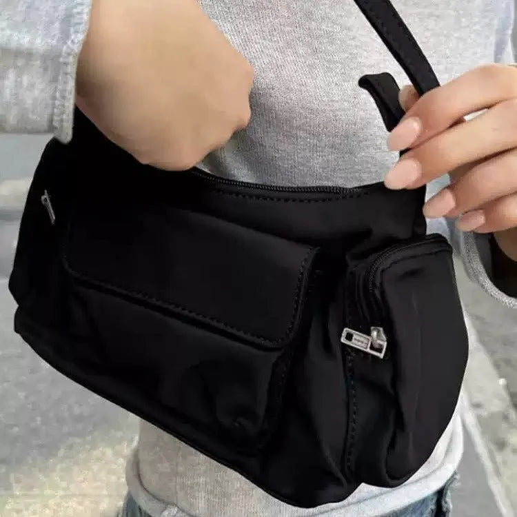 Black nylon lightweight double pocket women's shoulder bag showing side line detail