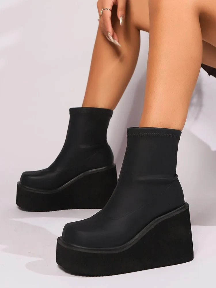 Women's black waterproof platform boots with wedge heels and round toe