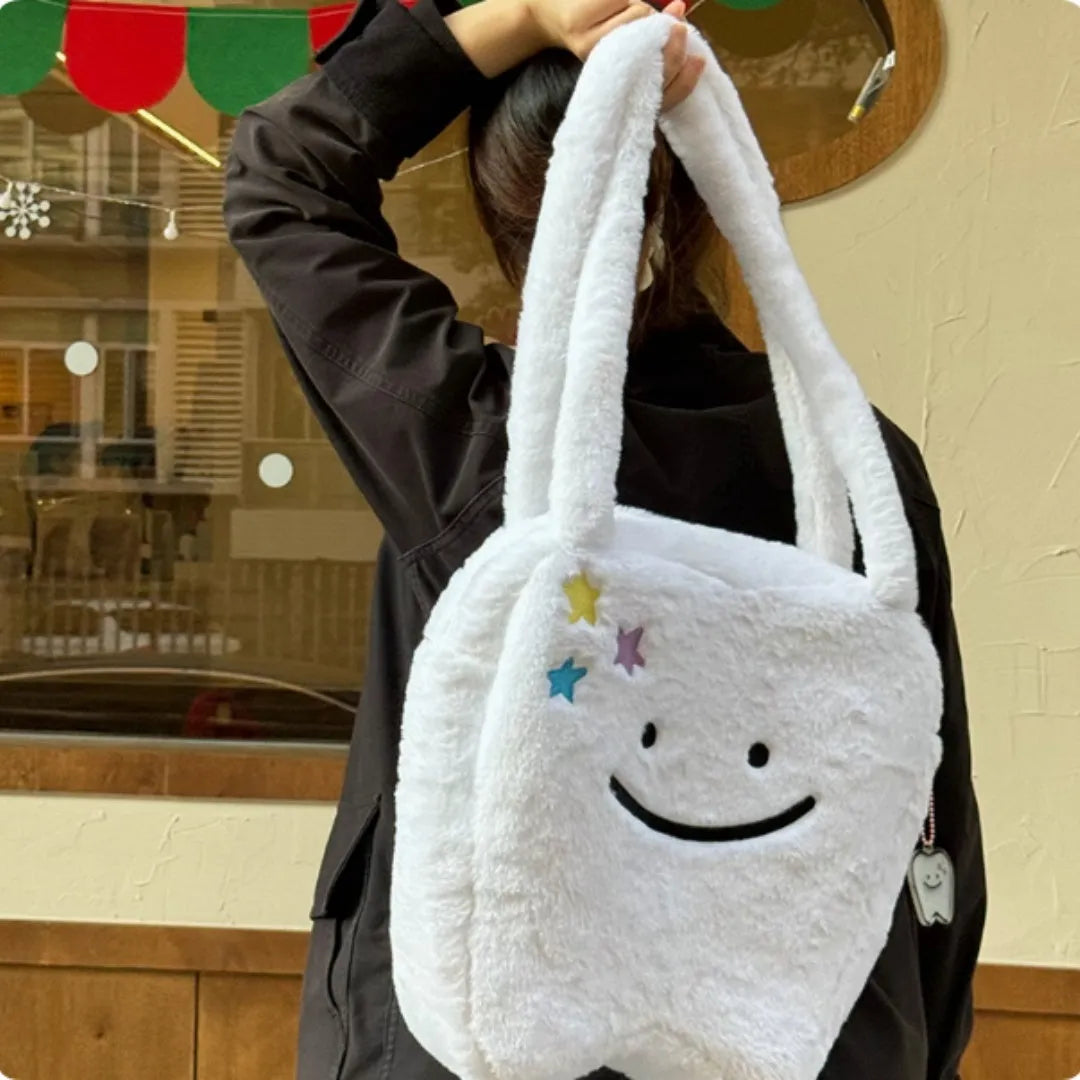 White large tote bag with plush large tooth shoulder strap and cute teeth design