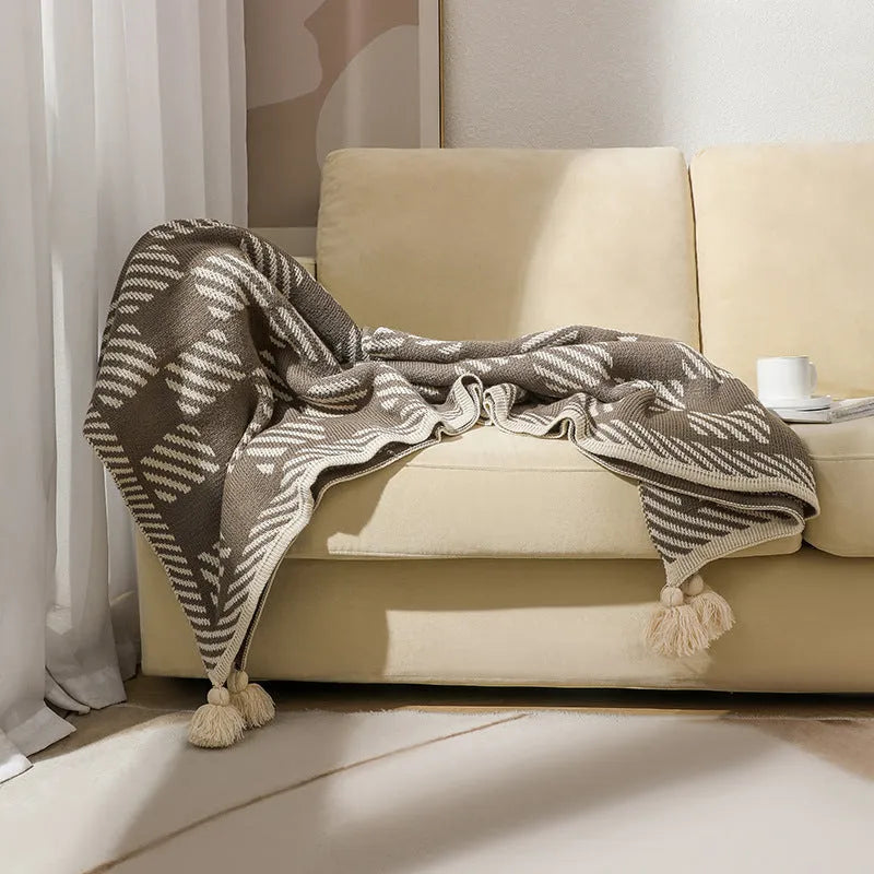 Bohemian-style acrylic sofa cover blanket with tassel trim in a geometric pattern colour option