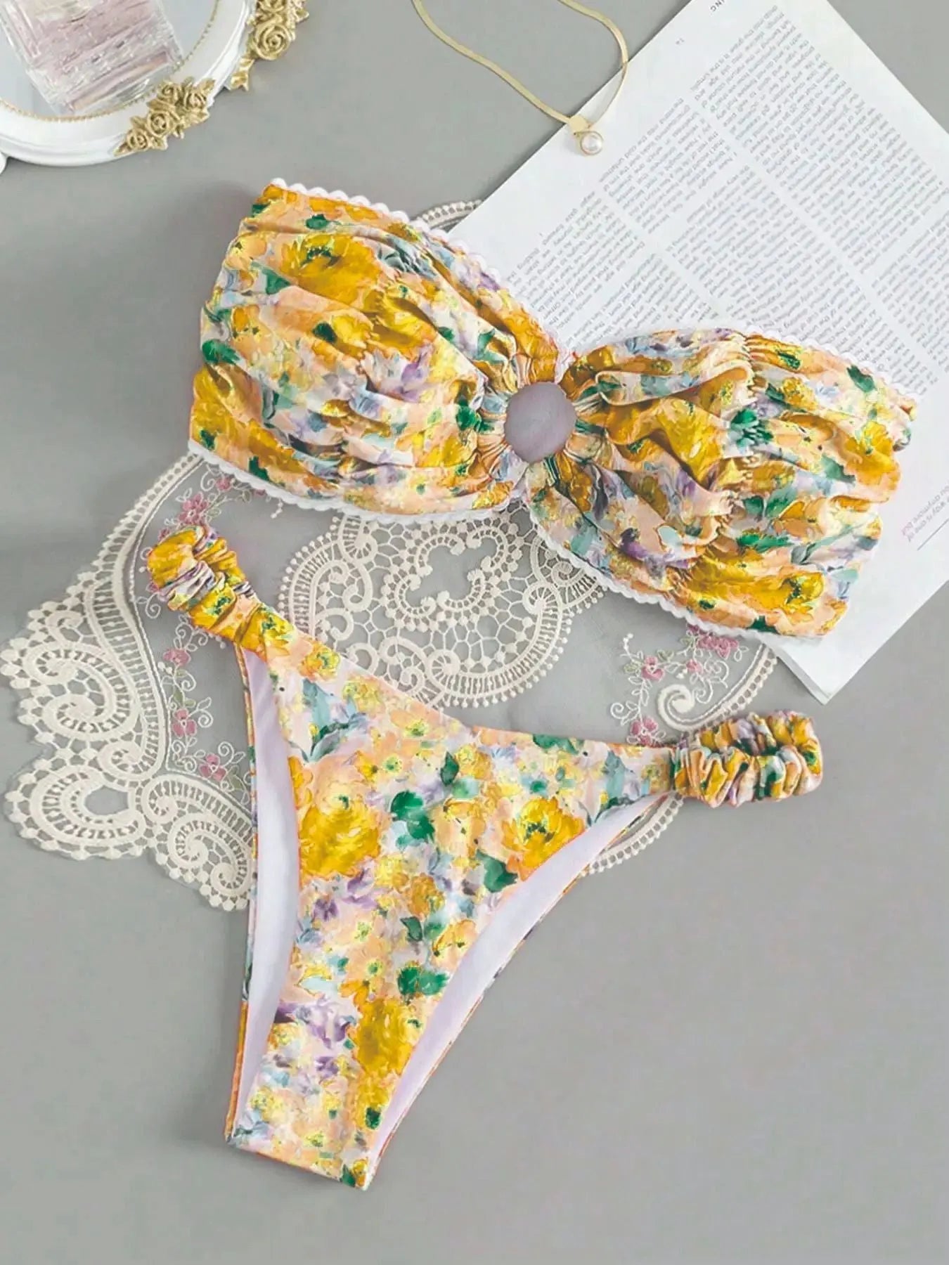 Floral print blue bikini tube top with lace trim and backless design for swimming.