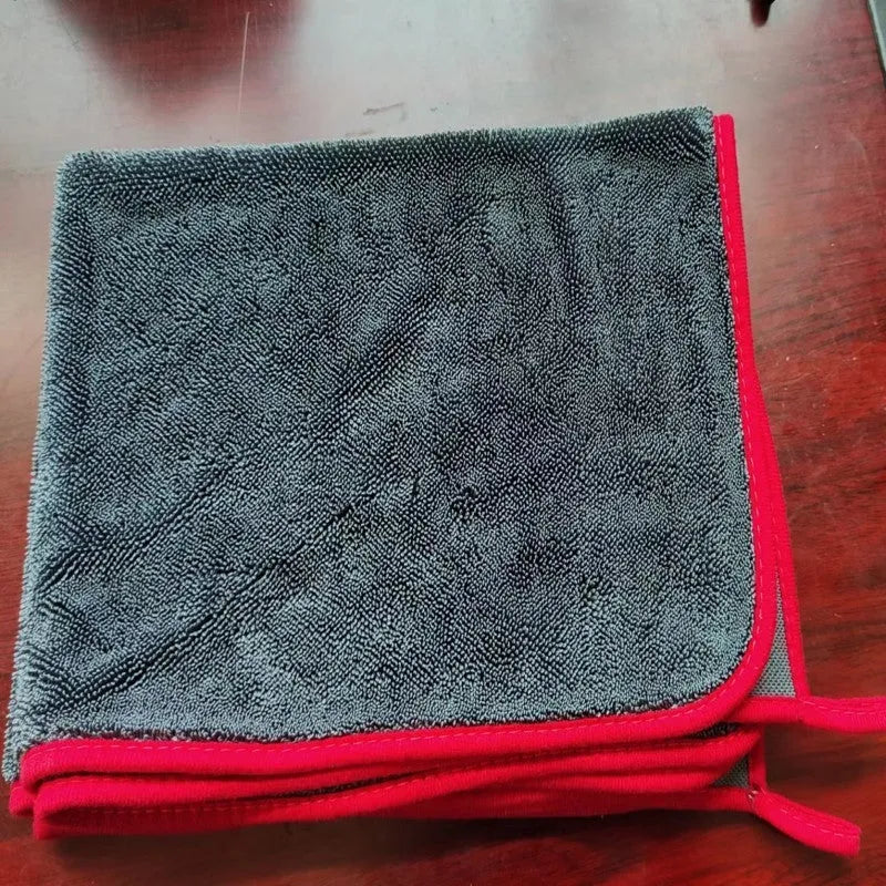 Small braid twisted car cleaning towel in grey with red edge trim, showing textured surface