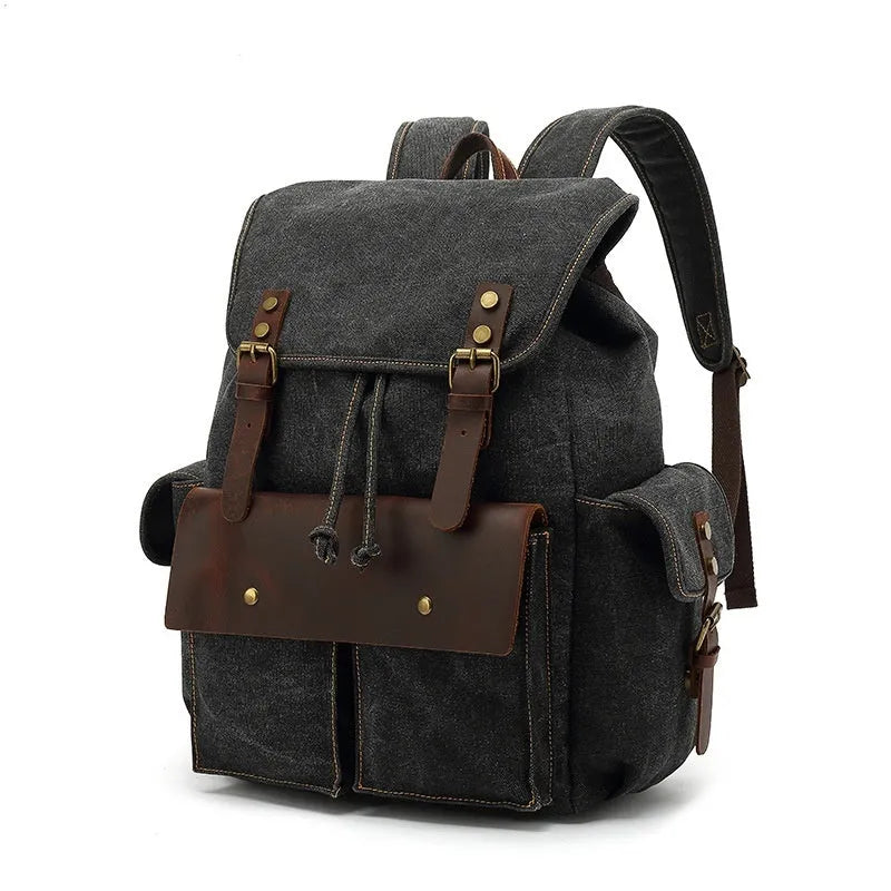 Retro-style canvas backpack in military green with antique bronze hardware, shown with a 16-inch laptop.
