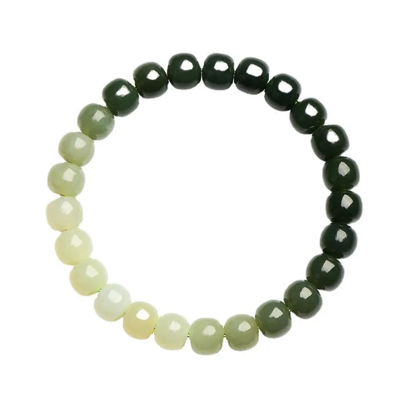 Natural Hetian jade bracelet showing gradient water colour and polished oval beads.