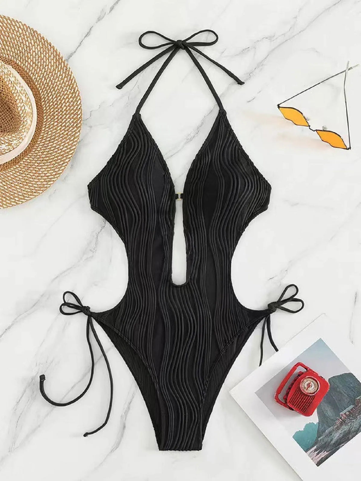 Women's black triangle bikini with lace-up front detail on solid colour background