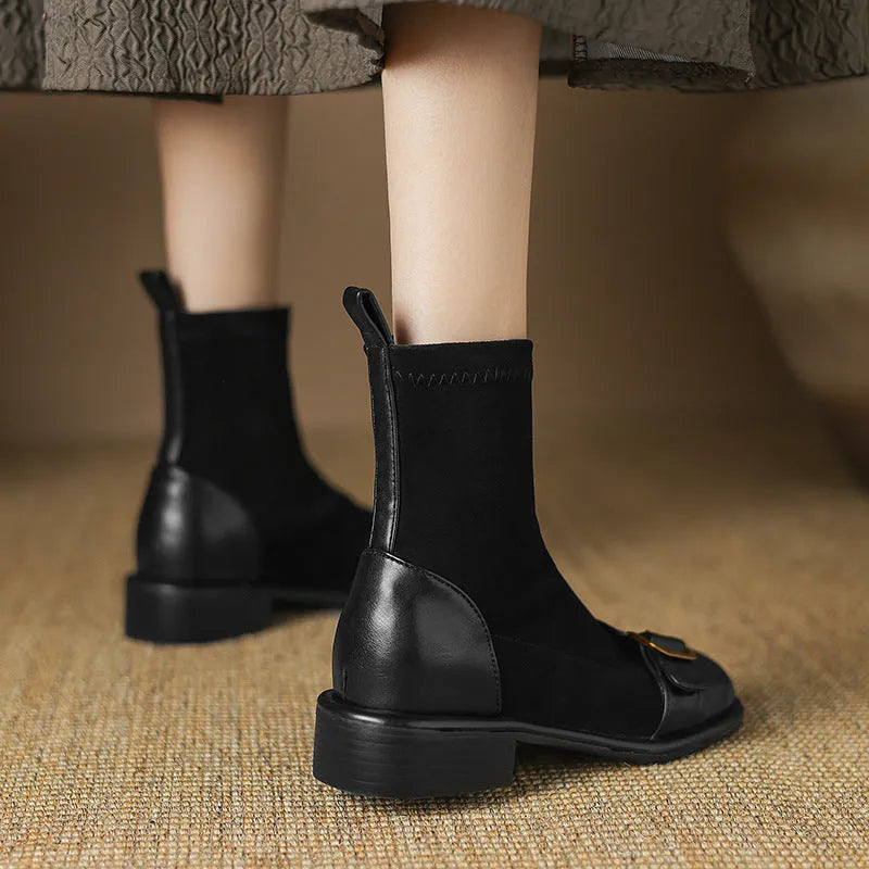 Women's black low heel Martin-style ankle boots with belt buckle stitching and front lace-up fastening.