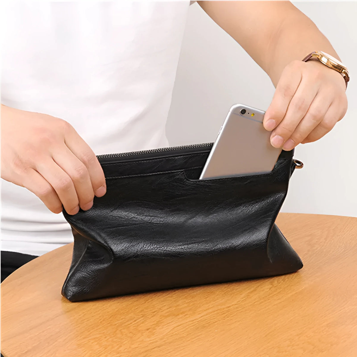 Men's PU leather clutch bag in black with wrist strap, soft carry handle, and zipper compartments