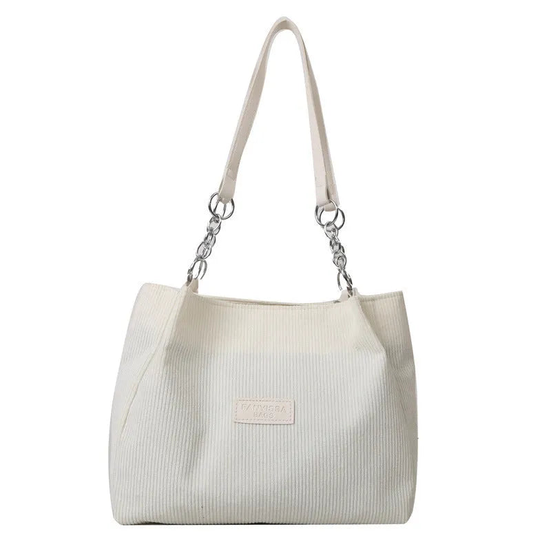 Corduroy one-shoulder tote bag with three-dimensional front pocket in street style design