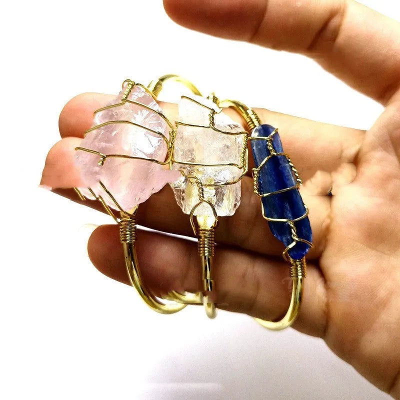 Geometric gold wire bracelet with unshaped natural rough stone crystals in bohemian style.