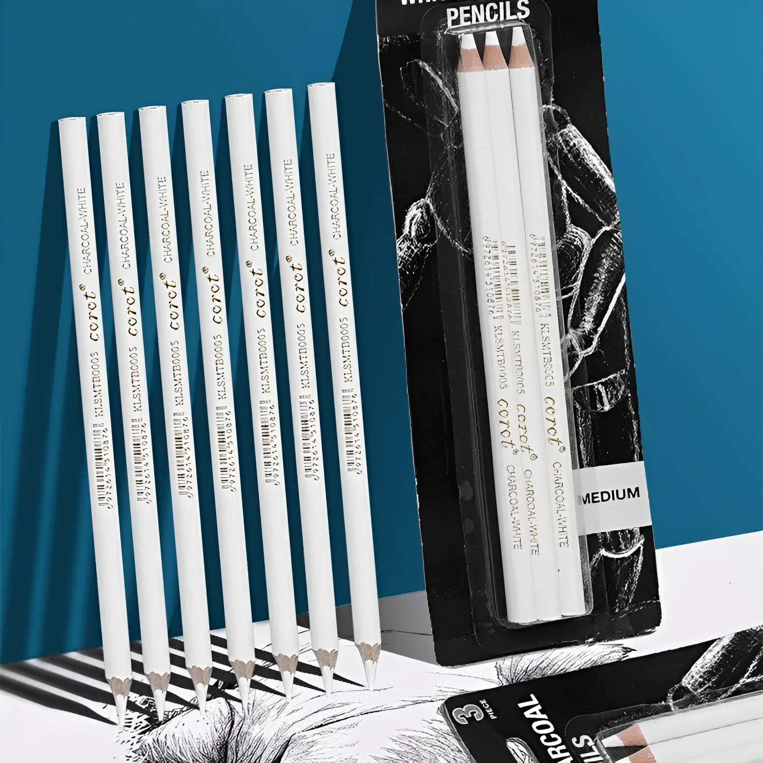 Three white charcoal pencils in wooden casings for drawing highlights on dark paper