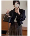 Women's brown retro slim fit imitation leather coat with long sleeves and pockets.