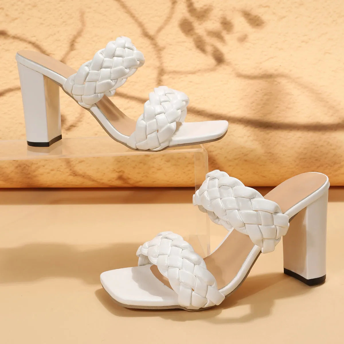 Square toe flip-flop with chunky heel and woven twisted straps in apricot colour.