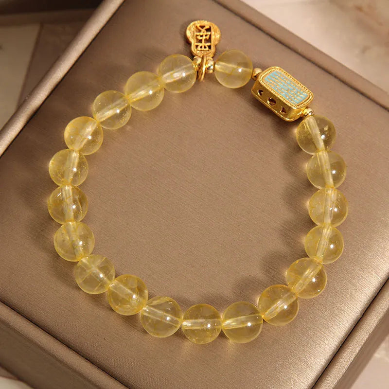Women's yellow citrine crystal bracelet with rhinestone accents on wrist