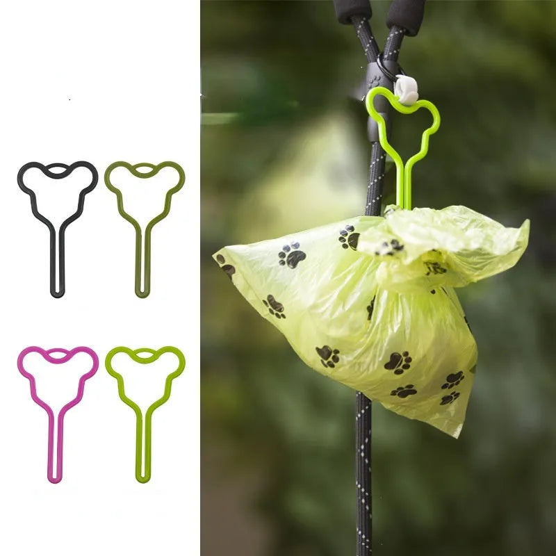 Dog waste bag holder with hands-free clip and Velcro strap attached to a dog leash