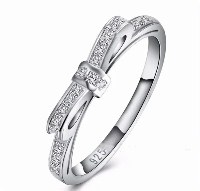 Silver bow-shaped ring with rhinestone zircon crystal decoration on model finger