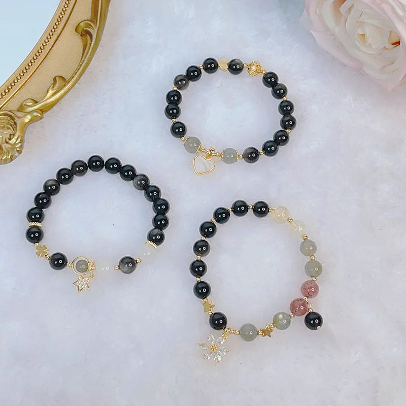 Women's silverstone bracelet with electroplated finish showing floral, love, and star charm designs