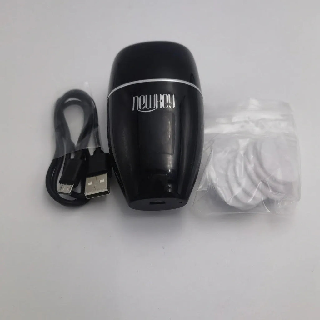 Black and white electric silicone lip plumper device with USB charging cable.