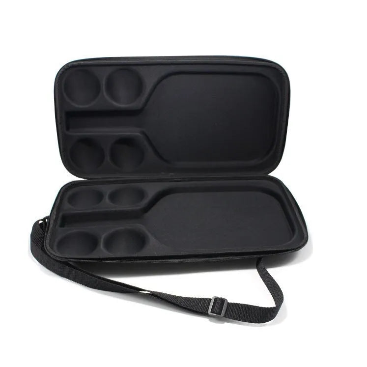 Black hard-shell EVA pickleball racket bag with double shoulder straps, shown holding one paddle and four balls.