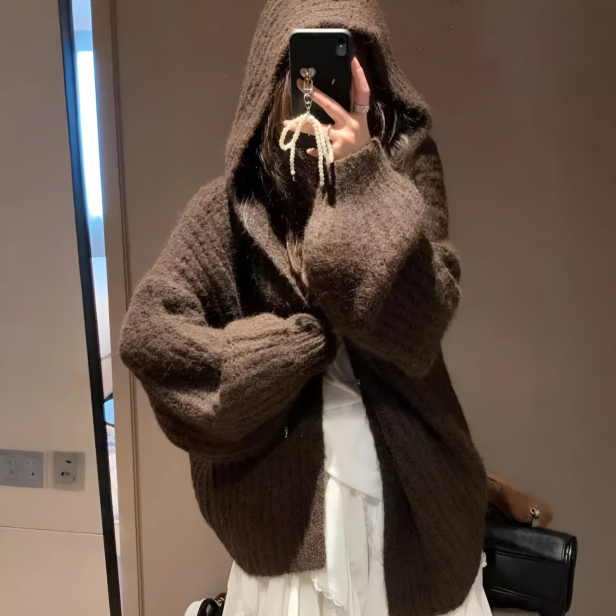 A loose-fit, thick acrylic hooded cardigan sweater for women, shown in a macaron colour.