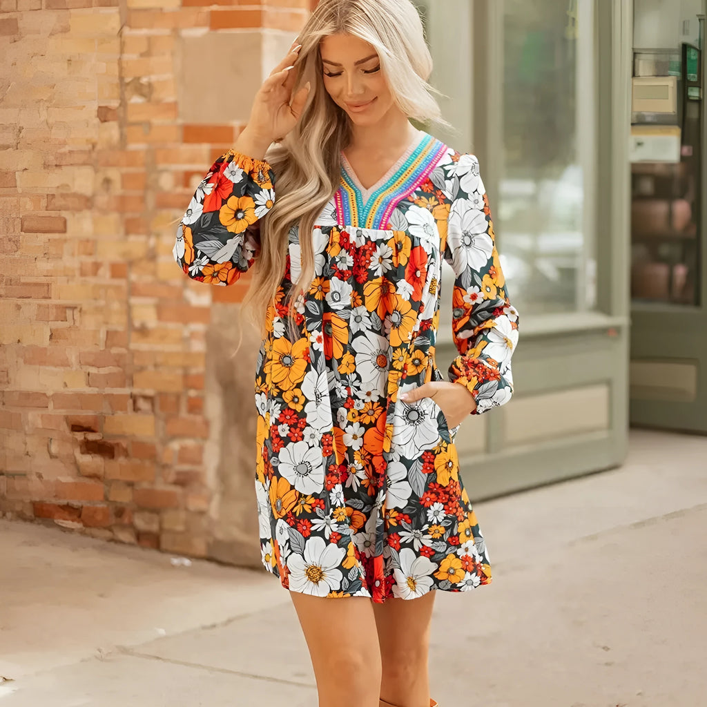 Orange floral print women's mini dress with V-neck, long sleeves, and lace trim