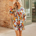 Orange floral print women's mini dress with V-neck, long sleeves, and lace trim