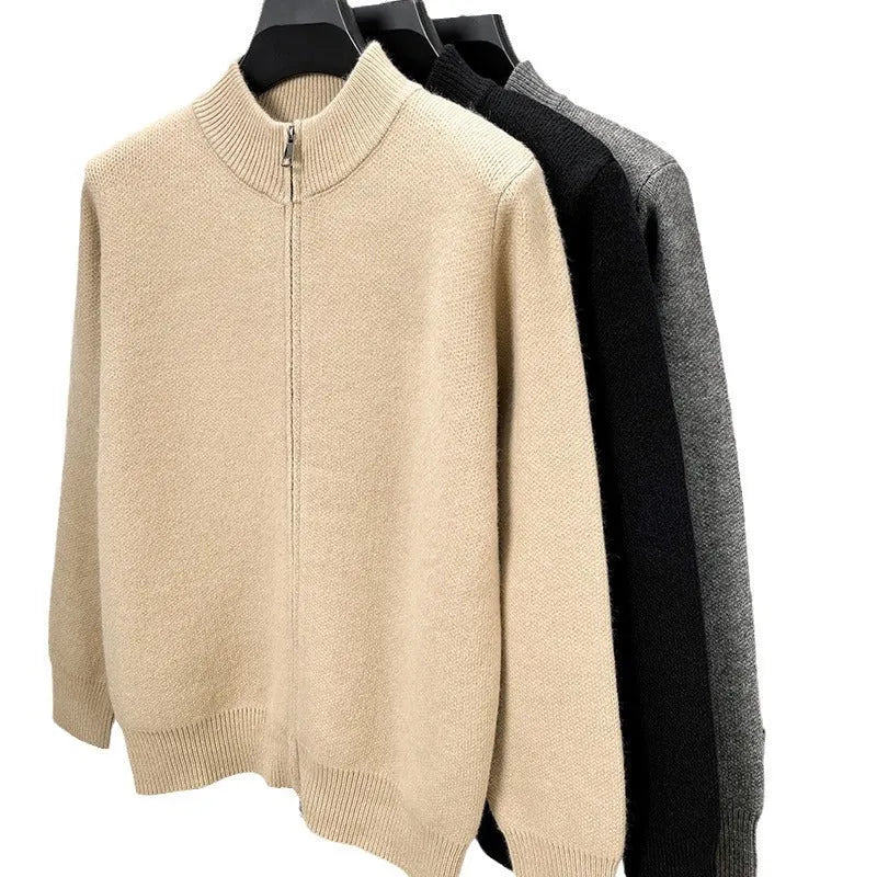Man wearing a loose-fit, grey, stand collar knitted cardigan with a full-length front zipper.