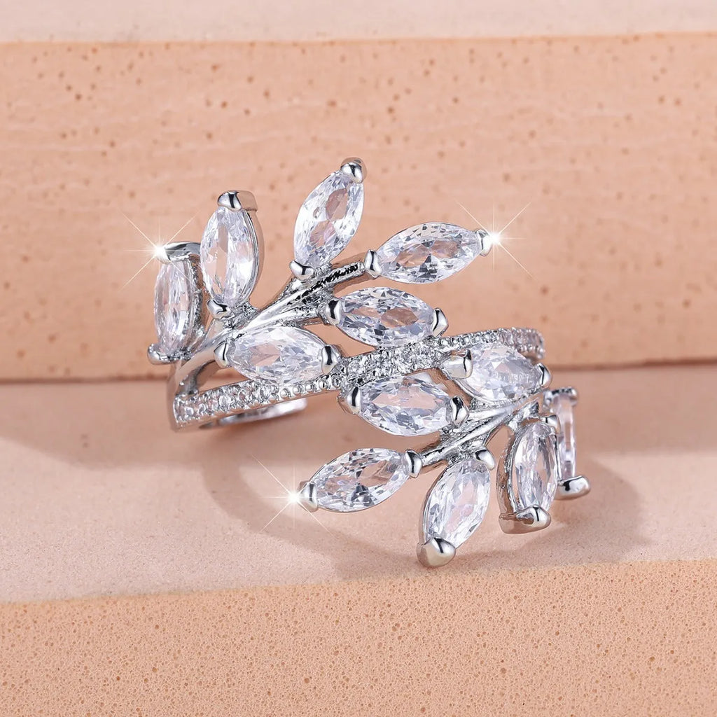 Copper leaf-shaped fashion ring with zircon details and an adjustable opening, shown in a rose gold finish.