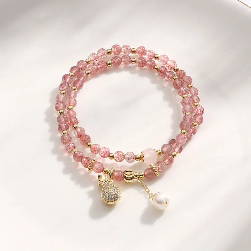 Strawberry quartz crystal bracelet with geometric pink beads on adjustable string