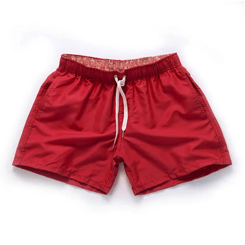 Men's polyester beach shorts in black, shown laid flat, featuring a straight leg opening.
