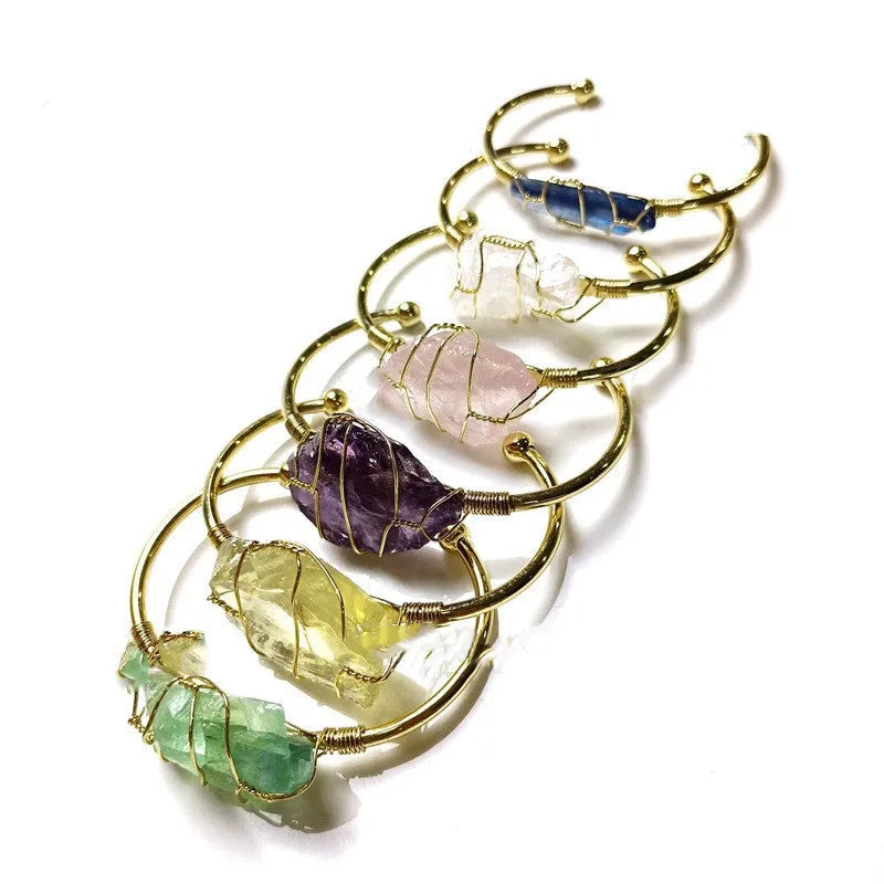 Geometric gold wire bracelet with unshaped natural rough stone crystals in bohemian style.