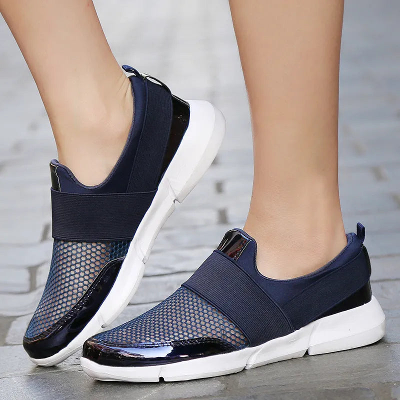 Women's low-cut casual sneakers in grey with mesh detail and PU midsole on a hard floor.