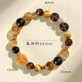 Yellow artificial crystal bracelet with 10mm Jinba large beads on a string.