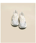 Women's gray retro sneaker with mesh lining and rubber sole on wooden floor