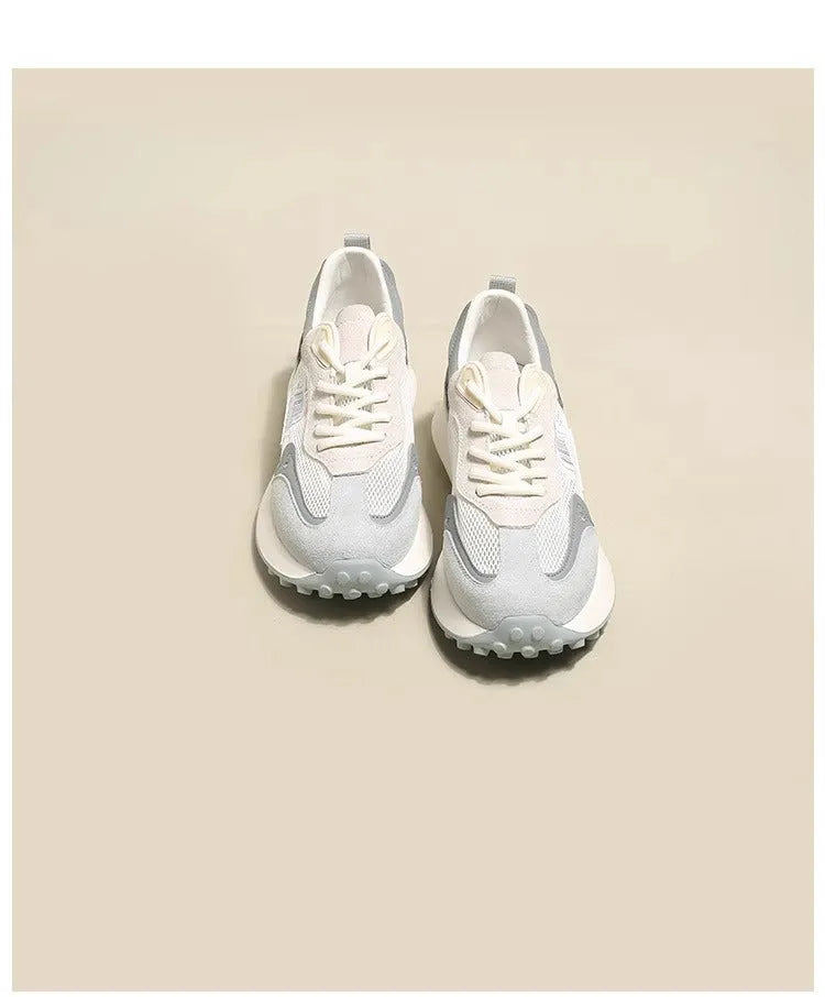 Women's gray retro sneaker with mesh lining and rubber sole on wooden floor