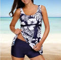 Blue women's printed split bikini swimsuit with sleeveless top and matching shorts on mannequin