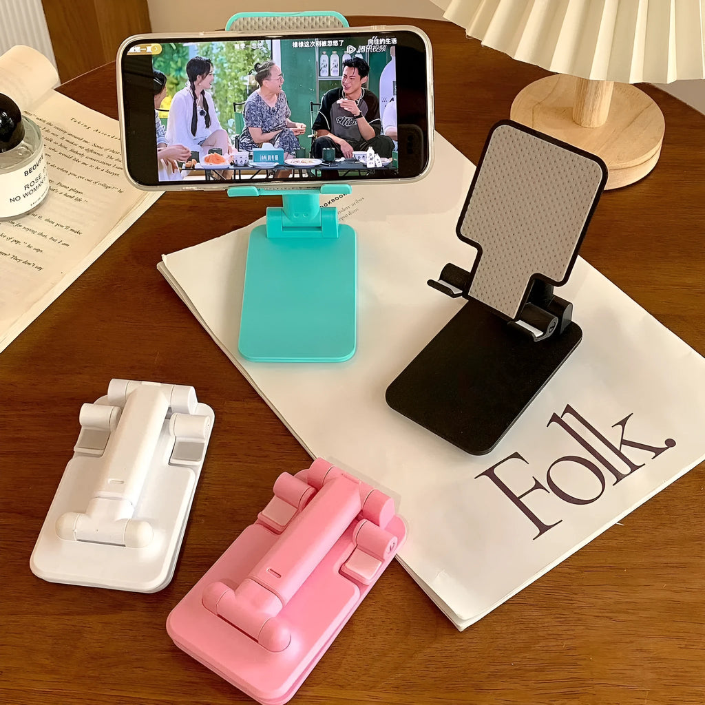 Folding universal plastic mobile phone stand in pearl white, deep black, mint green, and girl pink